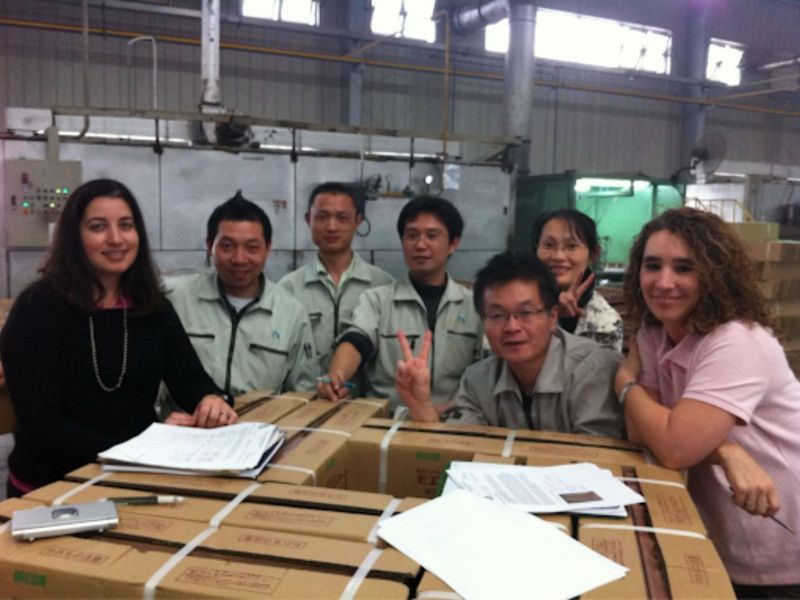 Carolina Baffigo with a manufacturing team at a factory